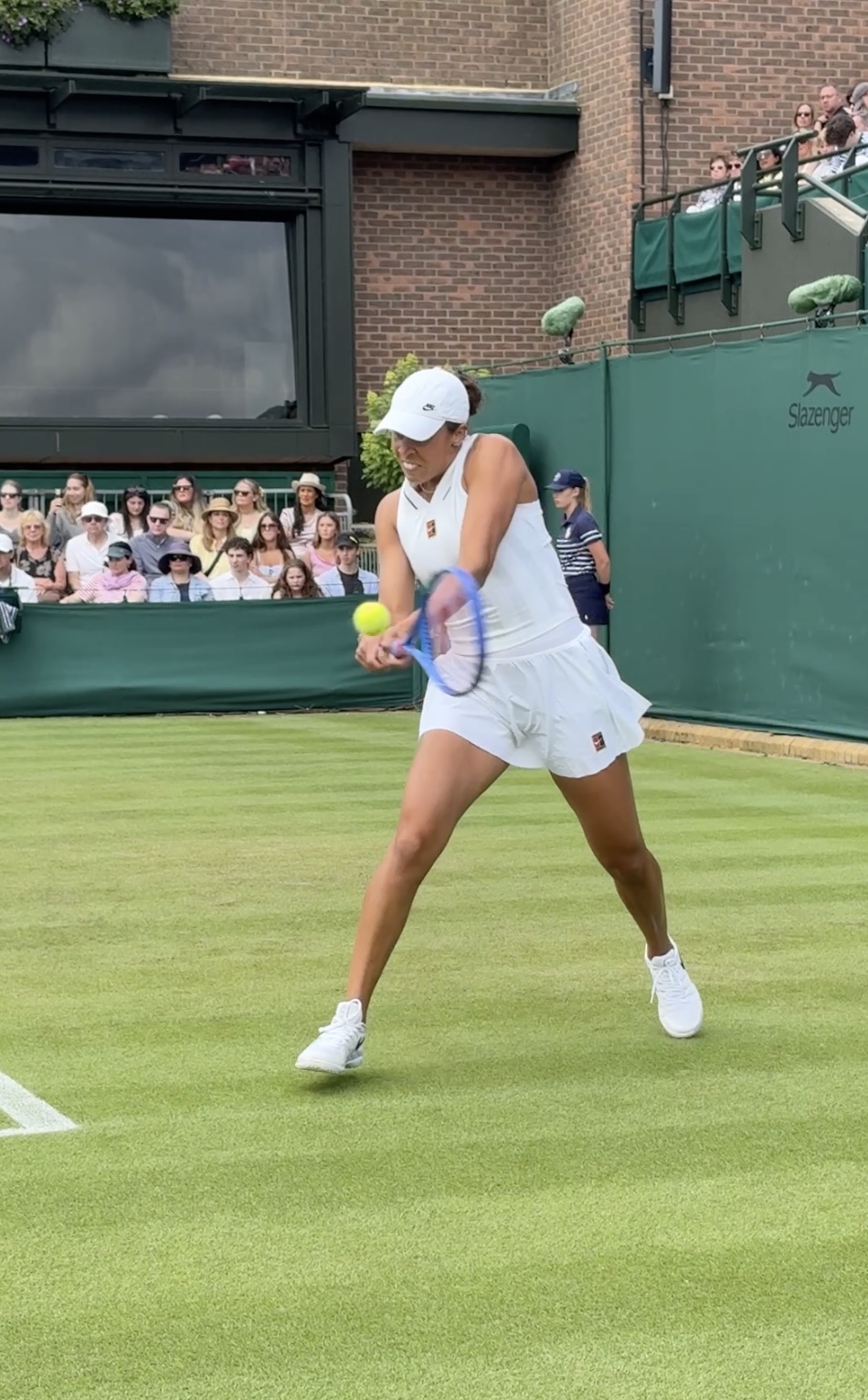 Tennis player hitting a backhand at Wimbledon