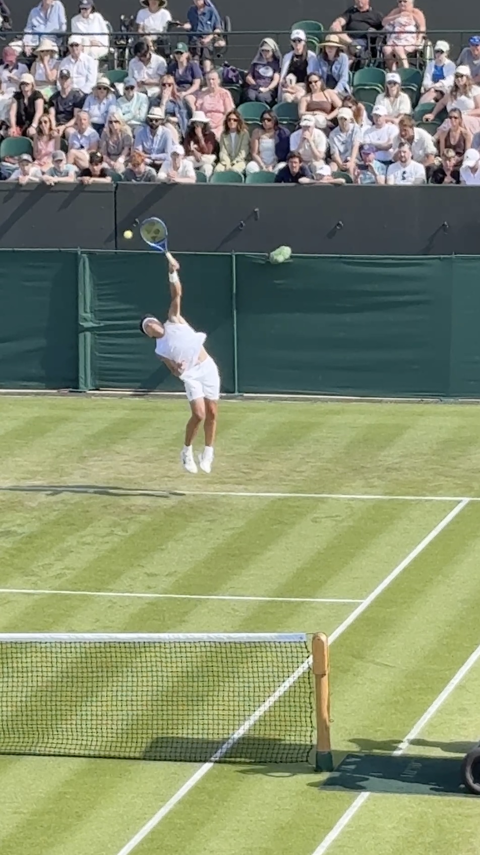 Tennis player serving at Wimbledon